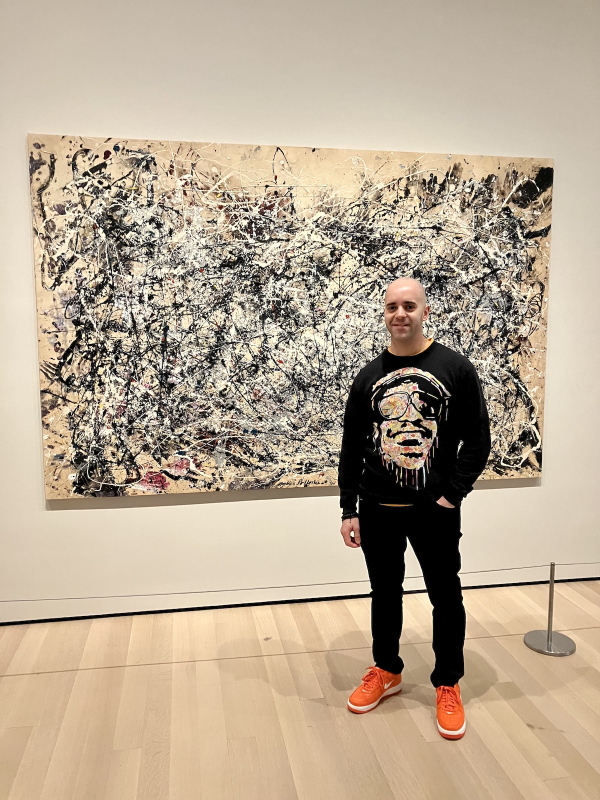 Kerwin next to Jackson Pollock painting, Number 1A, 1948, at the Museum of Modern Art, New York