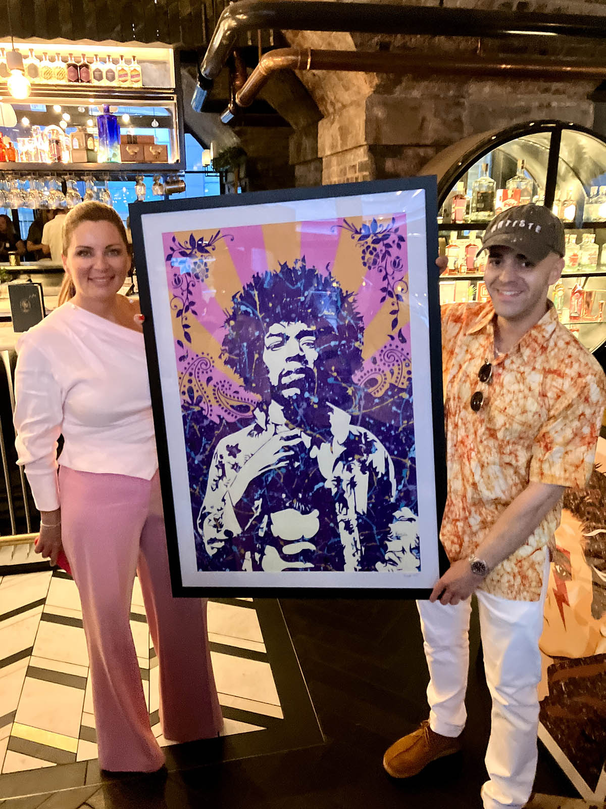 Kerwin Blackburn presenting a hand-embellished Jimi Hendrix print to its new owner in Manchester