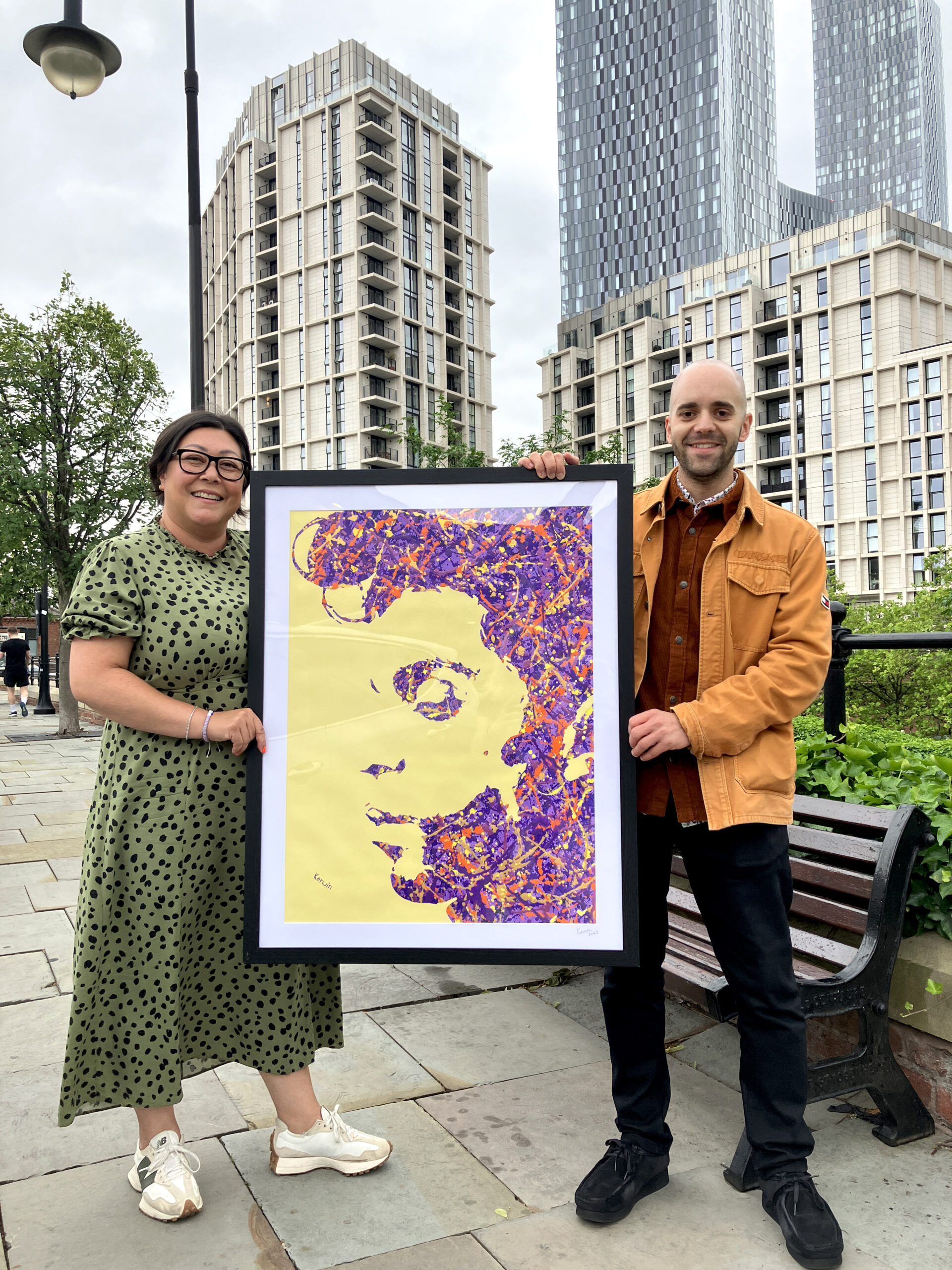 Kerwin Blackburn presenting a hand-embellished Prince print to its new owner in Manchester